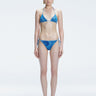 Front view of model wearing Hermione Blue Optical Bikini Bottom with low-waist cut and 3D printed design.
