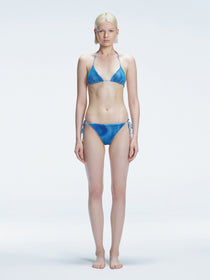 Front view of model wearing Hermione Blue Optical Bikini Set with triangle shape and 3D printed design.
