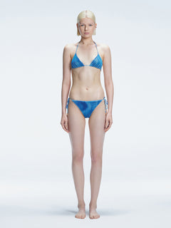 Front view of model wearing Hermione Blue Optical Bikini Top with triangle shape and 3D printed design.
