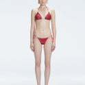 Front view of model wearing Hermione Red Optical Bikini Top with triangle shape and 3D printed design.
