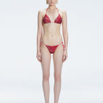 Front view of model wearing Hermione Red Optical Bikini Set with triangle shape and 3D printed design.
