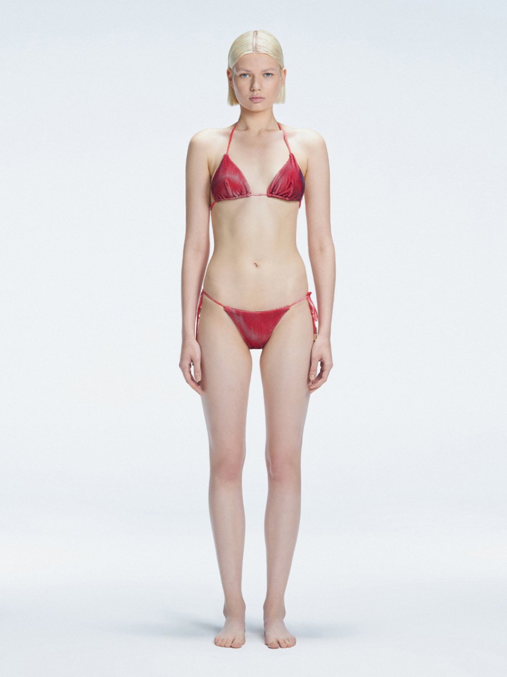 Front view of model wearing Hermione Red Optical Bikini Set with triangle shape and 3D printed design.
