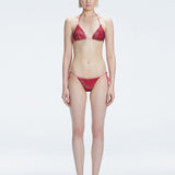 Front view of model wearing Hermione Red Optical Bikini Top with triangle shape and 3D printed design.
