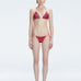 Front view of model wearing Hermione Red Optical Bikini Set with triangle shape and 3D printed design.
