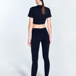 "Ida Black Leggings back view highlighting the ruched details and low waist design. The V-shaped waistline enhances the leggings' elegant look, while the stretchable material ensures comfort and flexibility."