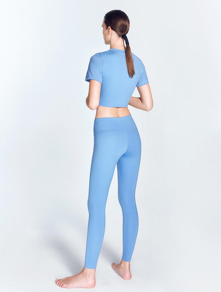 "Ida Blue Leggings back view highlighting the ruched detailing and low waist design. The V-shaped waistline enhances the leggings' stylish look, while the stretchable material ensures a comfortable and flexible fit."