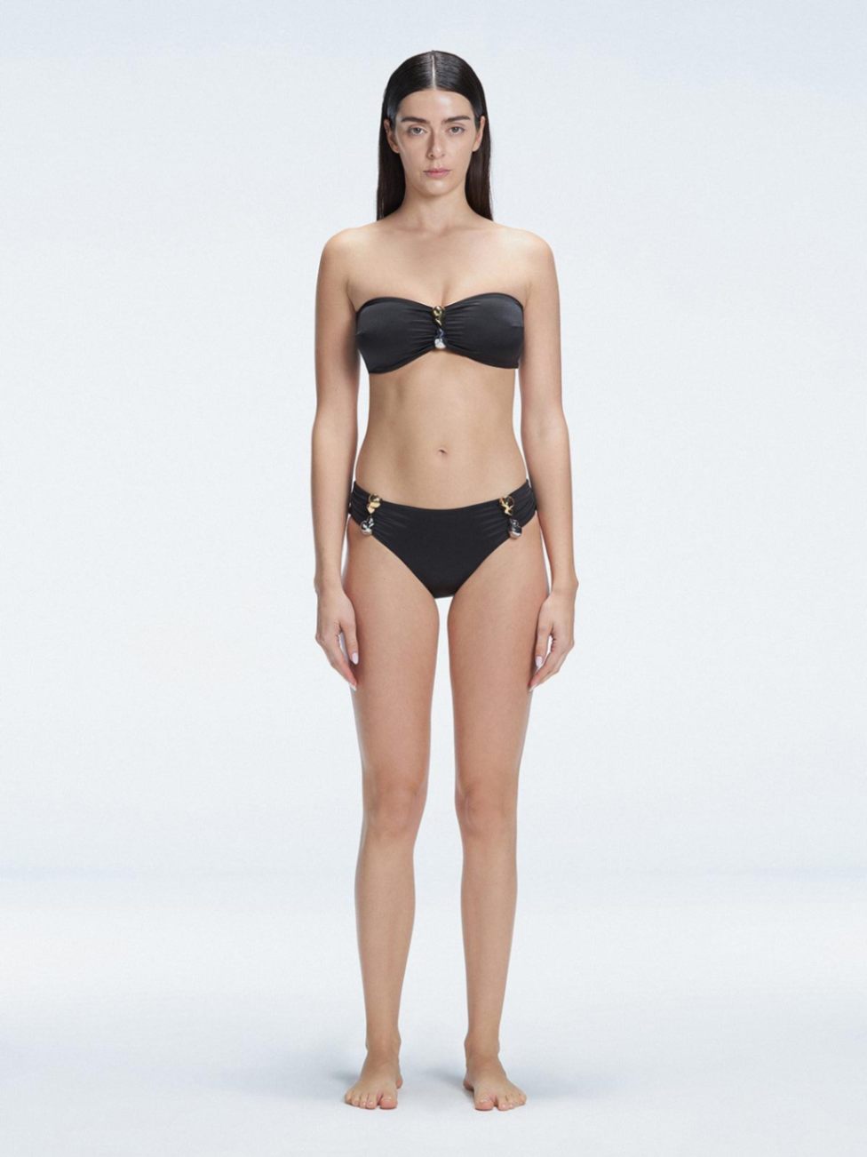 "Model wearing the Ilana Black Bikini Top from the front, showcasing the chic bandeau style and elegant buckle detail."

