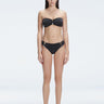 "Model wearing the Ilana Black Bikini Top from the front, showcasing the chic bandeau style and elegant buckle detail."

