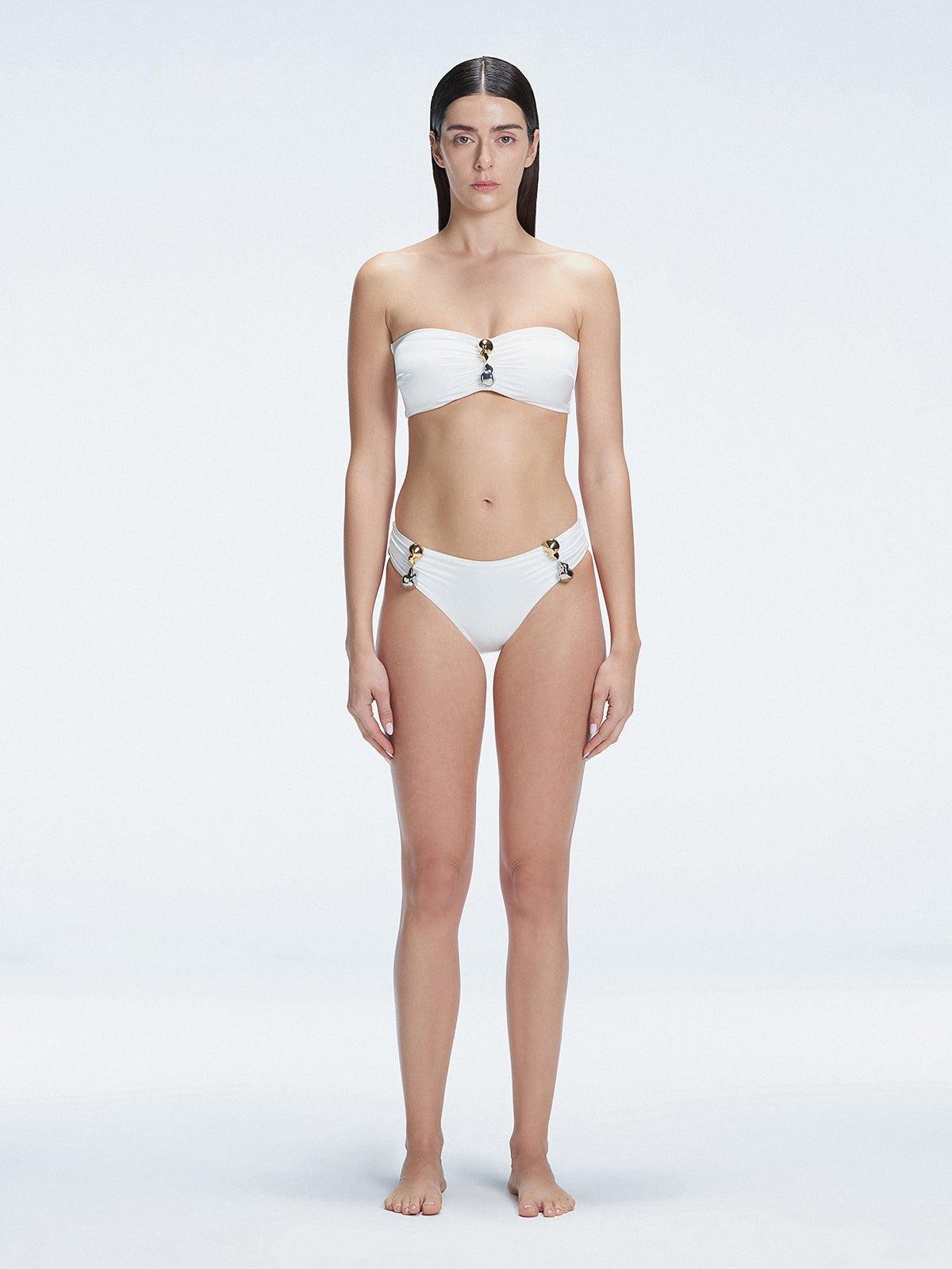 "Model wearing the Ilana White Bandeau Bikini Top with buckle and ruched detailing, posing by the pool."
