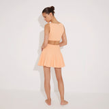 Lanao Orange Cut-Out Knit Mini Dress with Gold Detail | Moeva | RTW Dresses | Each week unveils new pieces—luxury swimwear, fluid resort silhouettes, and elevated summer-to-evening essentials designed to carry you from coastal escapes to city nights.
