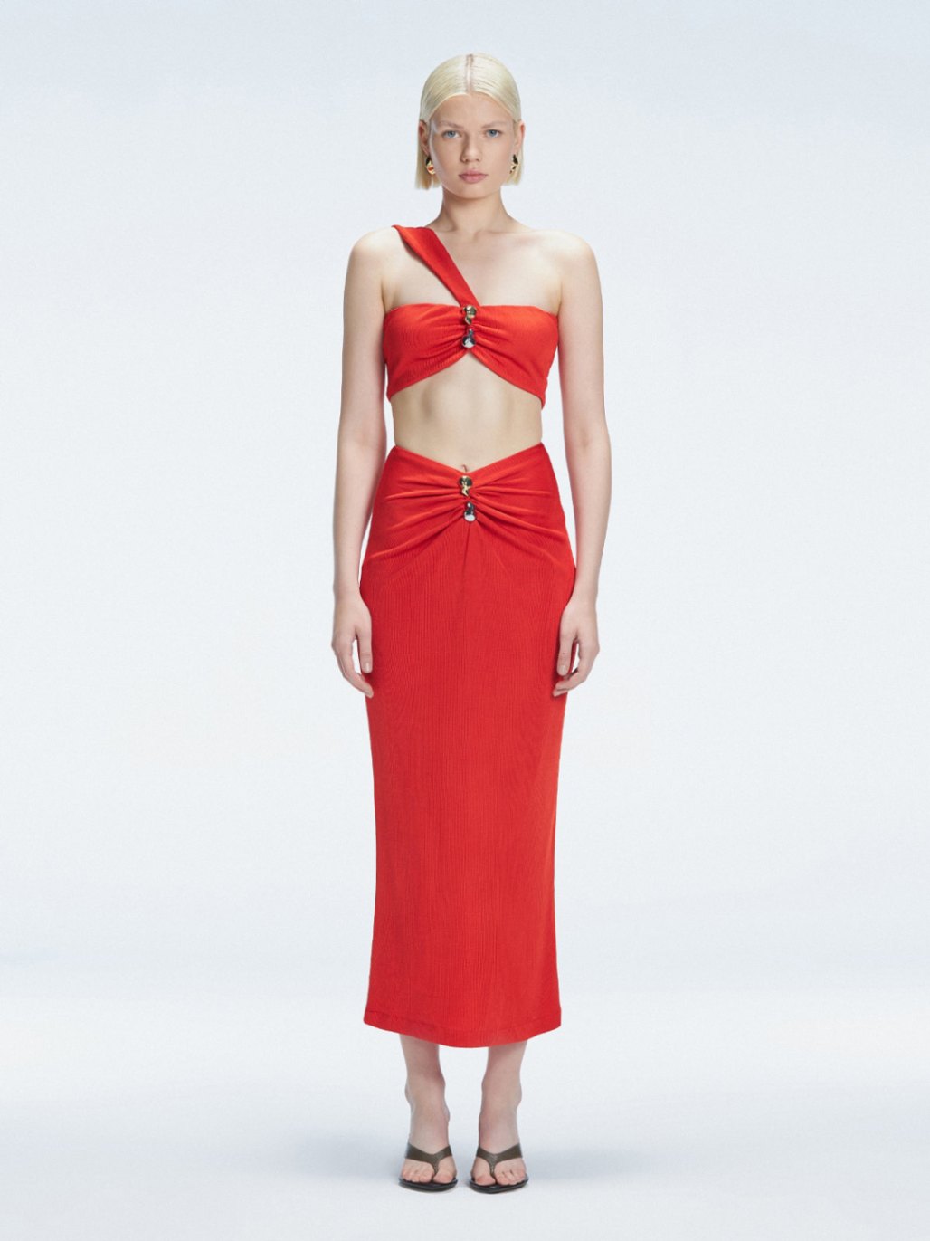 Front view of model wearing Esmeralda Red Midi Skirt with ruched and buckle detailing.
