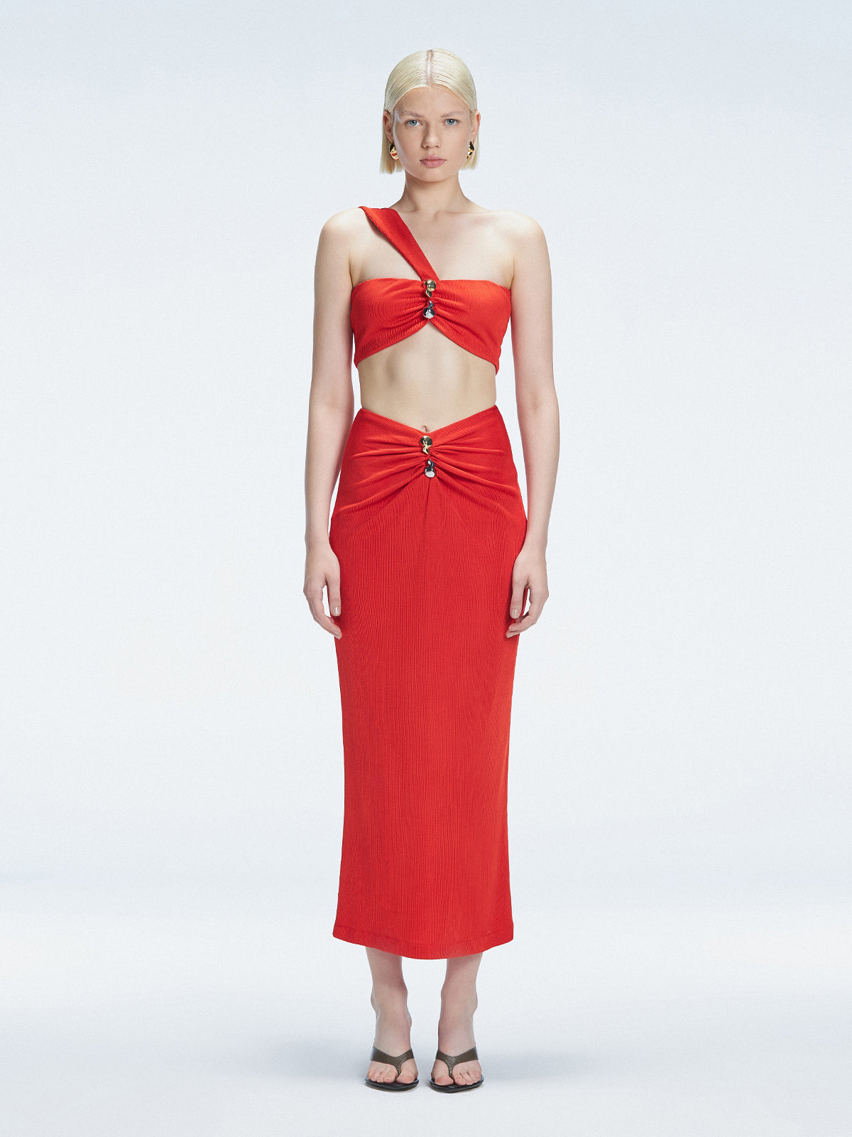 Front view of model wearing Esmeralda Red Midi Skirt with ruched and buckle detailing.
