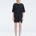 Front view of model wearing Lavinia Black Tee Dress with oversized fit and chic buckle detail.
