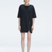 Front view of model wearing Lavinia Black Tee Dress with oversized fit and chic buckle detail.
