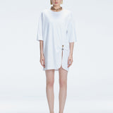 Front view of model wearing Lavinia White Tee Dress with oversized fit and chic buckle detail.
