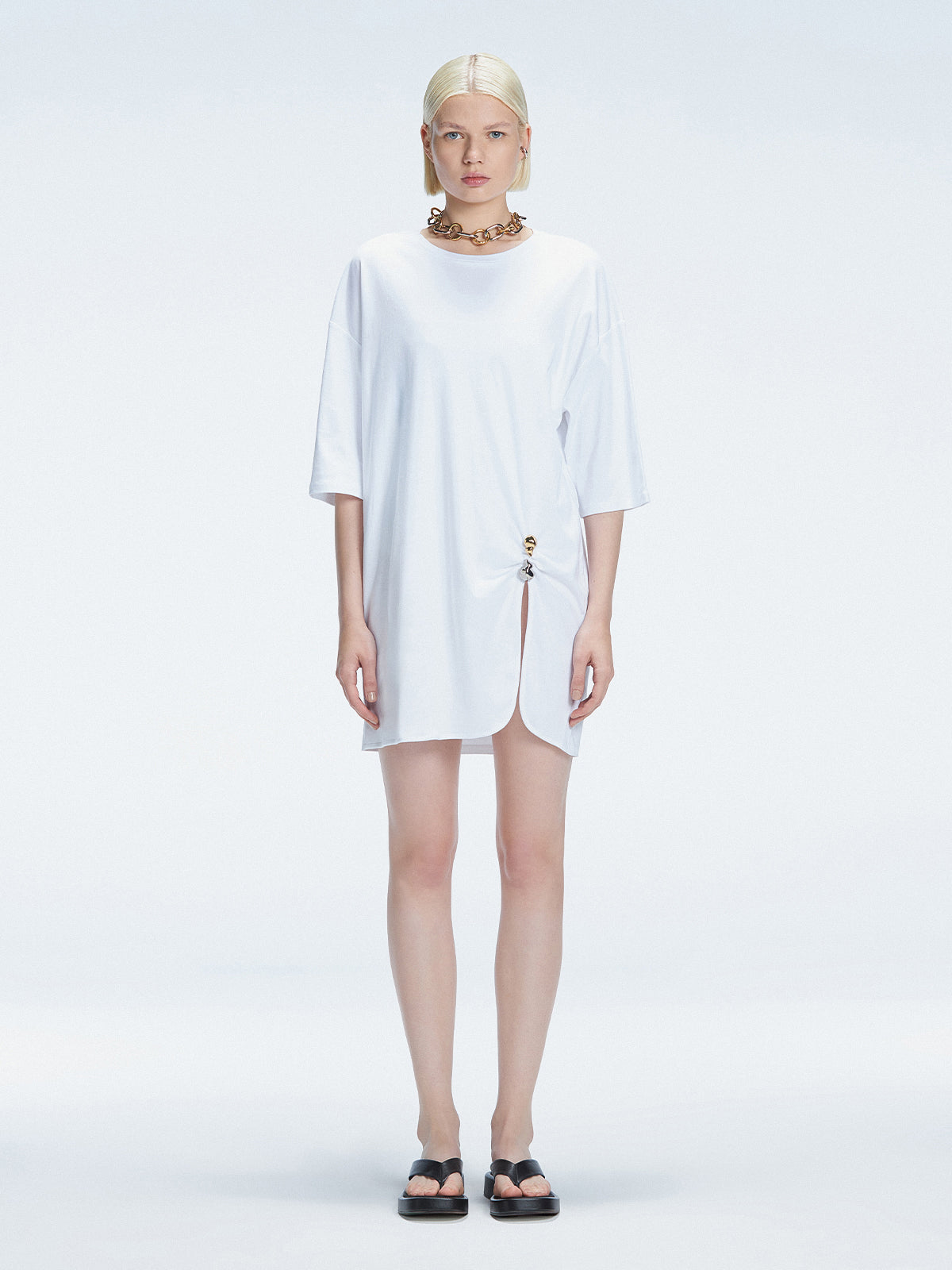 Front view of model wearing Lavinia White Tee Dress with oversized fit and chic buckle detail.
