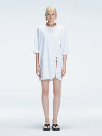 Front view of model wearing Lavinia White Tee Dress with oversized fit and chic buckle detail.
