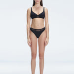 "Model wearing the Lorelai Black Bikini Set with a high-waisted design and mesh detail, posing by the pool."
