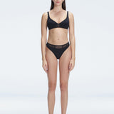 "Model wearing the Lorelai Black Bikini Set with a high-waisted design and mesh detail, posing by the pool."
