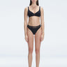 "Model wearing the Lorelai Black Bikini Set with a high-waisted design and mesh detail, posing by the pool."
