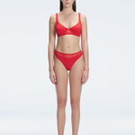 "Model wearing the Lorelai Red Bikini Top with a scoop neck and mesh detailing, posing by the pool."
