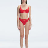 "Model wearing the Lorelai Red Bikini Top with a scoop neck and mesh detailing, posing by the pool."
