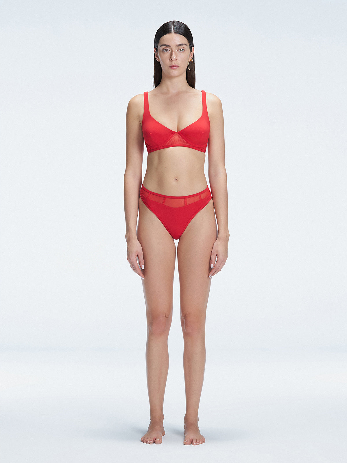 "Model wearing the Lorelai Red Bikini Top with a scoop neck and mesh detailing, posing by the pool."
