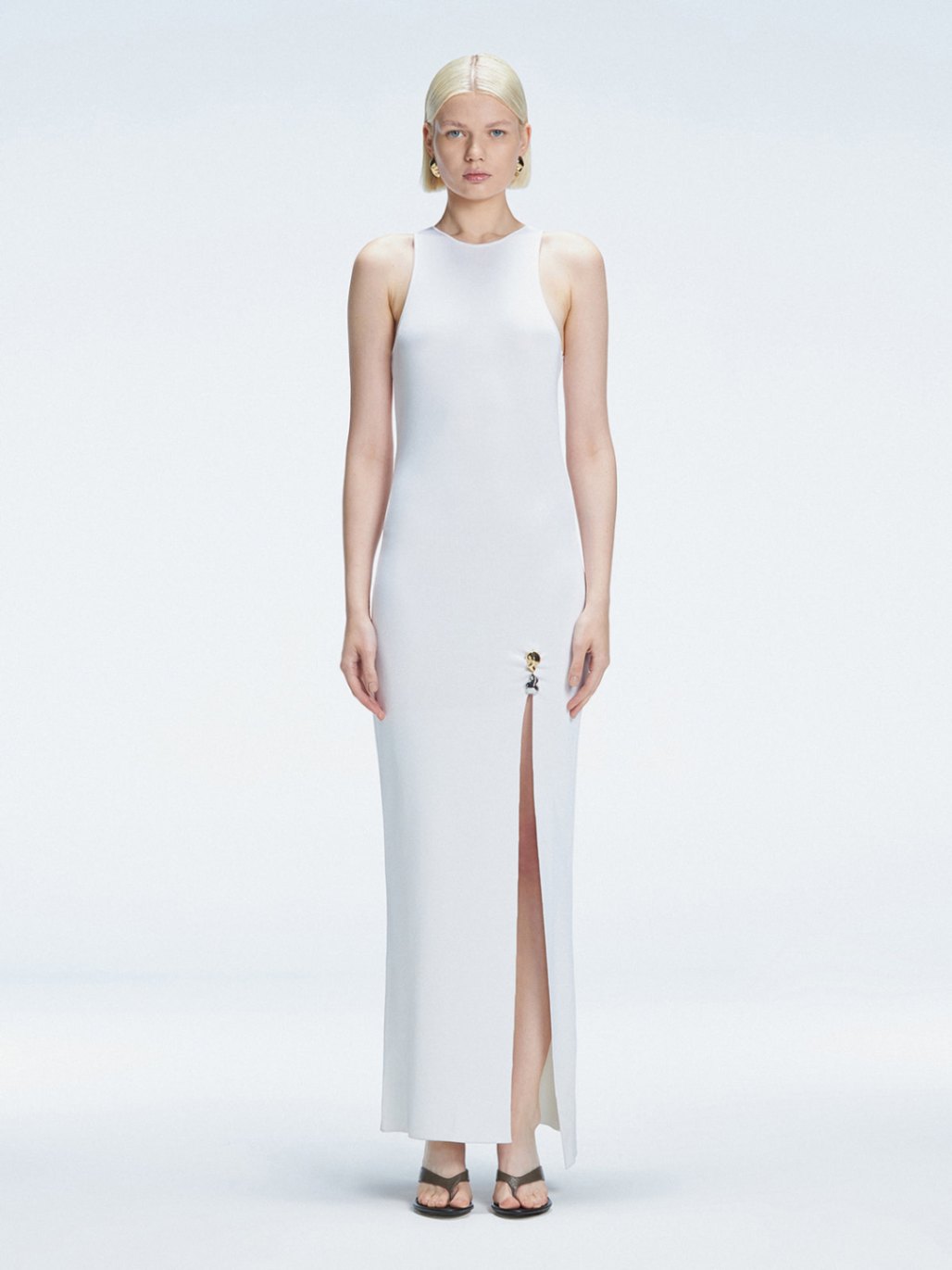 Front view of model wearing Louisa White Maxi Dress with high neck, sleeveless design, and buckle detail.
