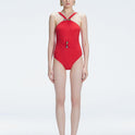 Model wearing the Lyra Red Underwired Swimsuit with ruched front and moderate bottom coverage.
