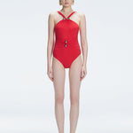 Model wearing the Lyra Red Underwired Swimsuit with ruched front and moderate bottom coverage.
