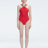 Model wearing the Lyra Red Underwired Swimsuit with ruched front and moderate bottom coverage.
