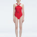 Model wearing the Lyra Red Underwired Swimsuit with ruched front and moderate bottom coverage.
