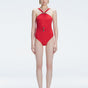 Model wearing the Lyra Red Underwired Swimsuit with ruched front and moderate bottom coverage.
