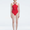 Model wearing the Lyra Red Underwired Swimsuit with ruched front and moderate bottom coverage.
