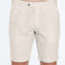 Beige shorts worn by a person on a white background