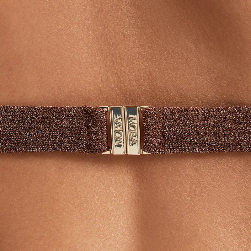 Close-up of Moeva swimwear fabric and signature metal clasp, highlighting premium materials, durability, and high-quality craftsmanship in sustainable design