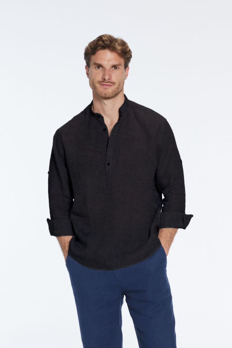 Man wearing a black shirt and blue pants on a white background