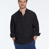 Man wearing a black shirt and blue pants on a white background