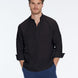Man wearing a black shirt and blue pants on a white background