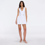 Meditara White Knit Mini Dress with Flared Skirt and Gold Button Details | Moeva | RTW Dresses | Each week unveils new pieces—luxury swimwear, fluid resort silhouettes, and elevated summer-to-evening essentials designed to carry you from coastal escapes to city nights.