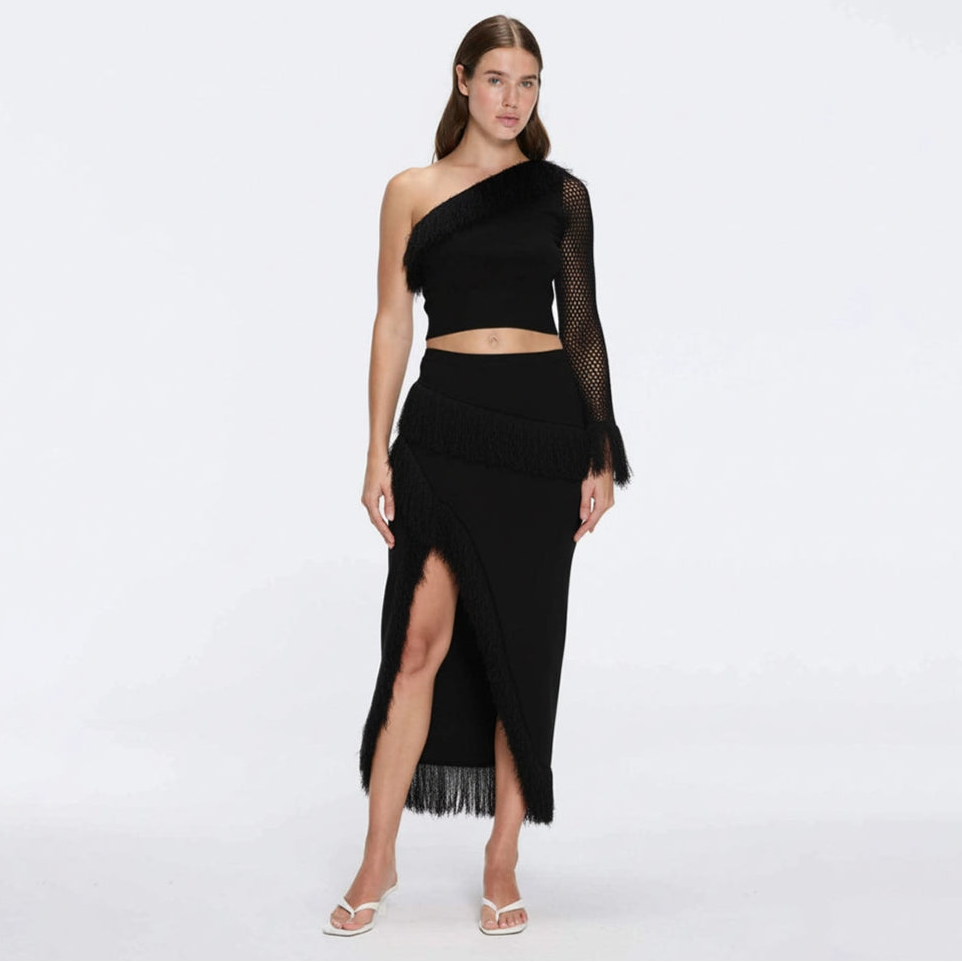 Monroe Black One-Shoulder Knit Top with Fringe & Mesh Sleeve | Moeva | Crop Top | Each week unveils new pieces—luxury swimwear, fluid resort silhouettes, and elevated summer-to-evening essentials designed to carry you from coastal escapes to city nights.