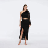 Alani Black Fringe Detail Asymmetric Slit Midi Skirt | Moeva | RTW Skirts | Each week unveils new pieces—luxury swimwear, fluid resort silhouettes, and elevated summer-to-evening essentials designed to carry you from coastal escapes to city nights.
