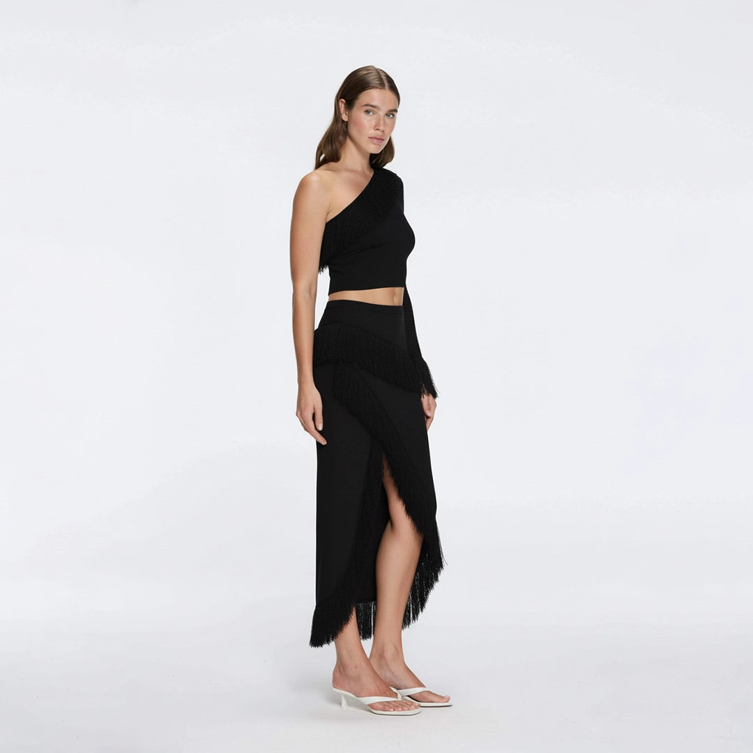 Alani Black Fringe Detail Asymmetric Slit Midi Skirt | Moeva | RTW Skirts | Each week unveils new pieces—luxury swimwear, fluid resort silhouettes, and elevated summer-to-evening essentials designed to carry you from coastal escapes to city nights.