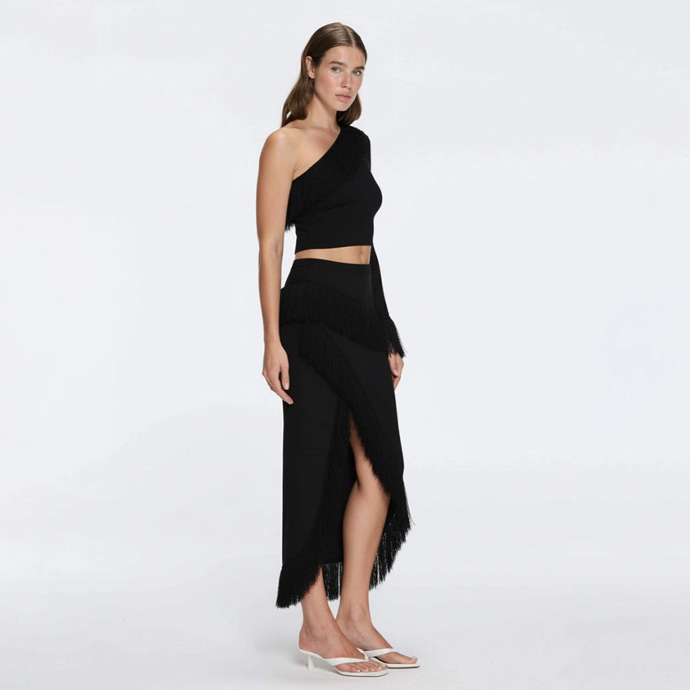 Monroe Black One-Shoulder Knit Top with Fringe & Mesh Sleeve | Moeva | Crop Top | Each week unveils new pieces—luxury swimwear, fluid resort silhouettes, and elevated summer-to-evening essentials designed to carry you from coastal escapes to city nights.