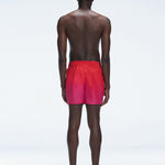 Back view of Griffin Red Gradient Swim Shorts, highlighting the bold pink-red gradient and comfortable fit.
