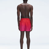 Back view of Griffin Red Gradient Swim Shorts, highlighting the bold pink-red gradient and comfortable fit.
