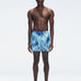 Griffin Blue Sonar Swim Shorts with front tie cords and side piping, laid flat for a detailed view.
