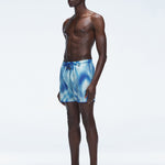 Model wearing Griffin Blue Swim Shorts with side piping and comfortable elastic waistband.
