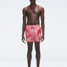 Model wearing Griffin Red Sonar Swim Shorts with printed fabric and sporty side piping.