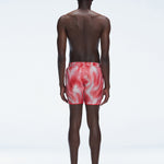 Back view of Griffin Red Sonar Swim Shorts on a model, displaying the vibrant print and functional details.
